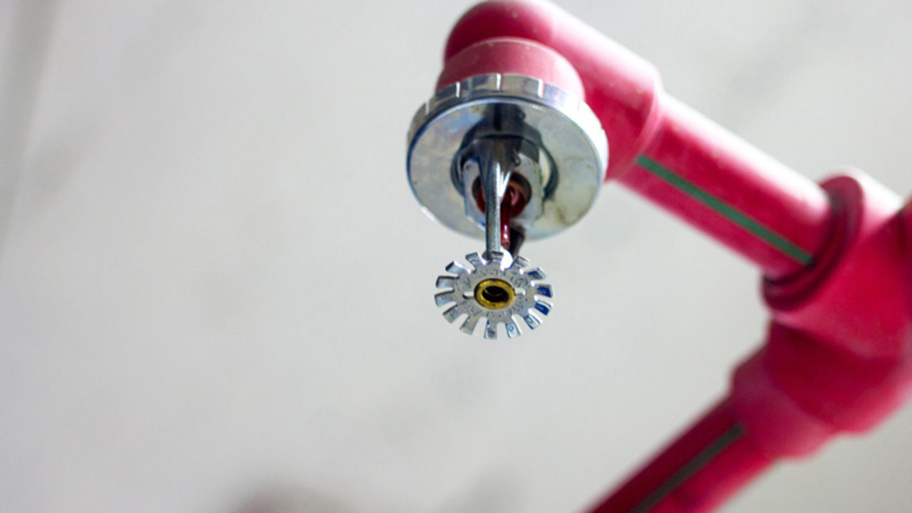 Fire sprinkler installation on warehouse ceiling