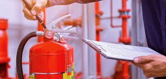 Technician inspecting fire safety equipment
